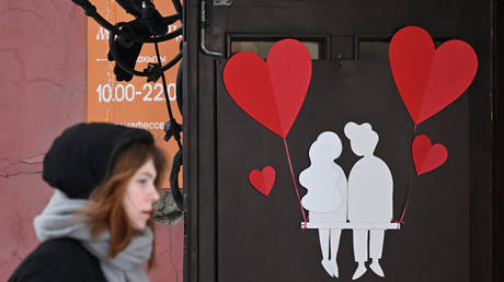 A young woman walks past Valentine's Day decorations in central Kazan, Russia.