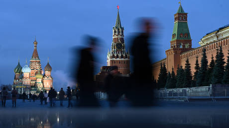 Pedestrians are walking near Kremlin at Red square in Moscow.